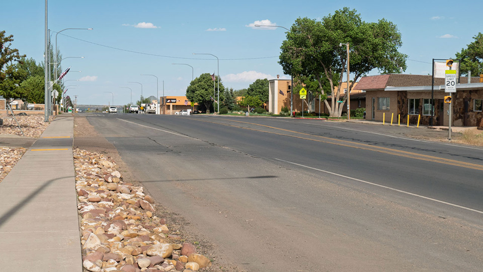 A small-town main street with a cafe, church and supermarket.