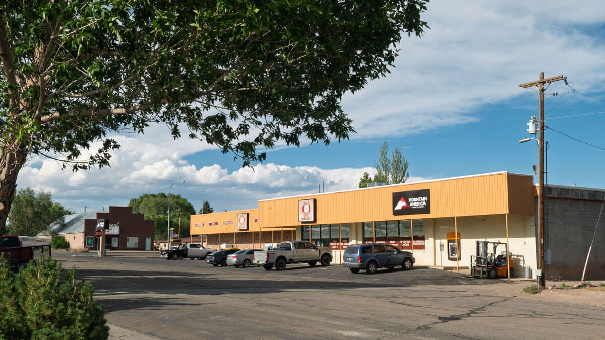 A small-town grocery store with an old theater building.
